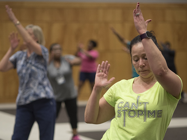 Jessie Lindsay, director of operations for The MIND Center, takes part in UMMC's Zumba class for employees.