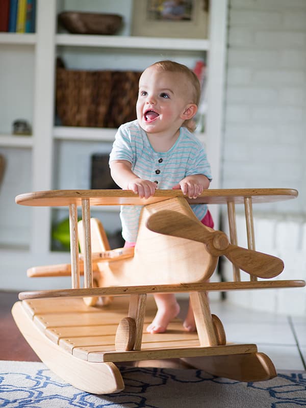 Bennett Backtrom, 15 months, plays on the airplane rocker that his dad, Miles Backtrom, built.
