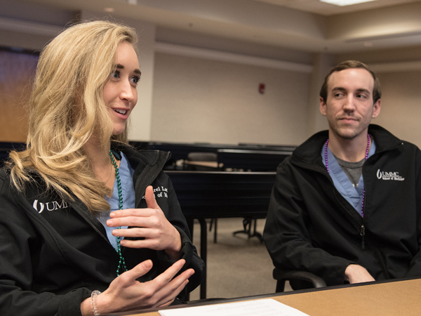 FrancoMed member Laurel Lackey, left, describes how she used her knowledge of French during a medical emergency in Paris, as Colton Lee listens in.