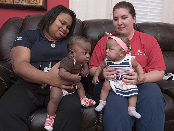 Brittney Course, left, and Shelly Fowler hold Course's twins, Carter and Carleigh Jae.