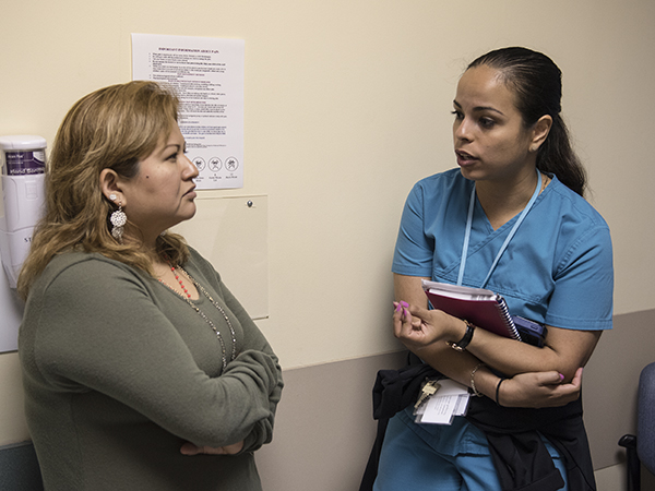 Martinez, left, listens to an explanation from Ortega during a visit to the Children's Cancer Clinic.