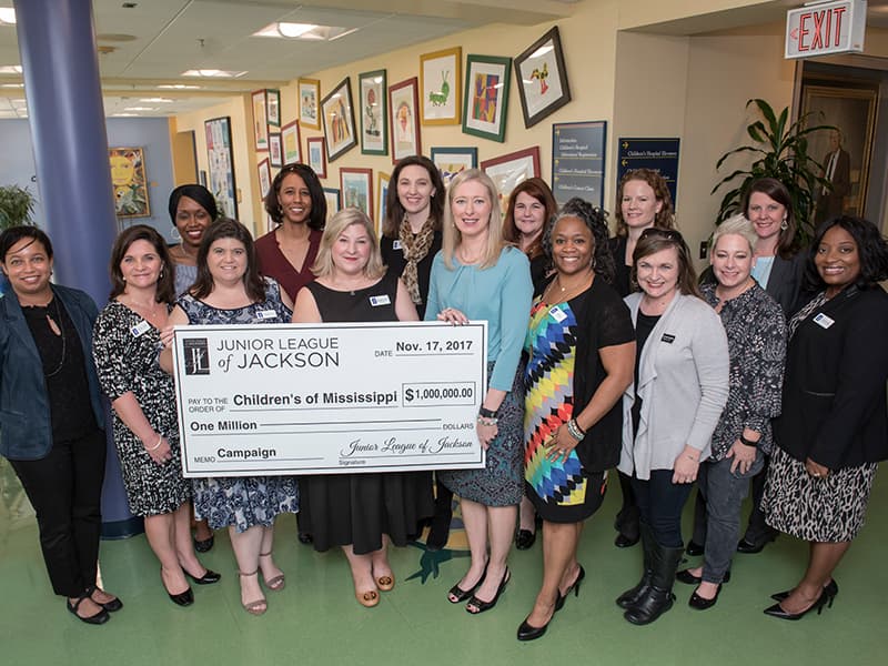 Junior League of Jackson members surround Noel in celebrating the organization's $1 million commitment to the Campaign for Children's of Mississippi.