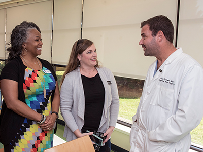 unior League of Jackson members, from left, Jia Scott and Lorraine Boykin talk with Dr. Brian Kogon, chief of pediatric cardiothoracic surgery.