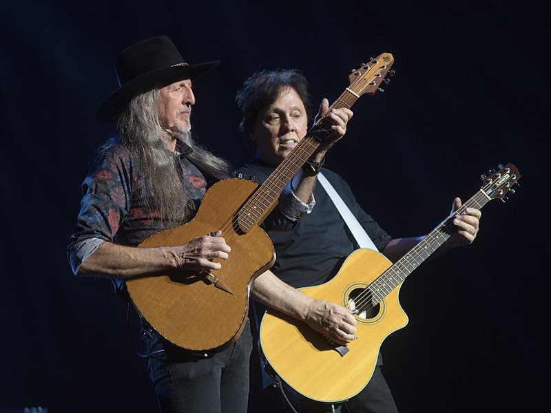 Pat Simmons, left and John McFee of The Doobie Brothers play acoustic guitar.