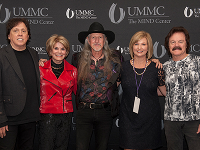 The Doobie Brothers held a meet and greet during to their concert. Pictured from left are John McFee, MIND Center Community Advisory Board Chair Suzan Thames, Pat Simmons, Vice Chancellor for health Affairs Dr. LouAnn Woodward and Tom Johnston.