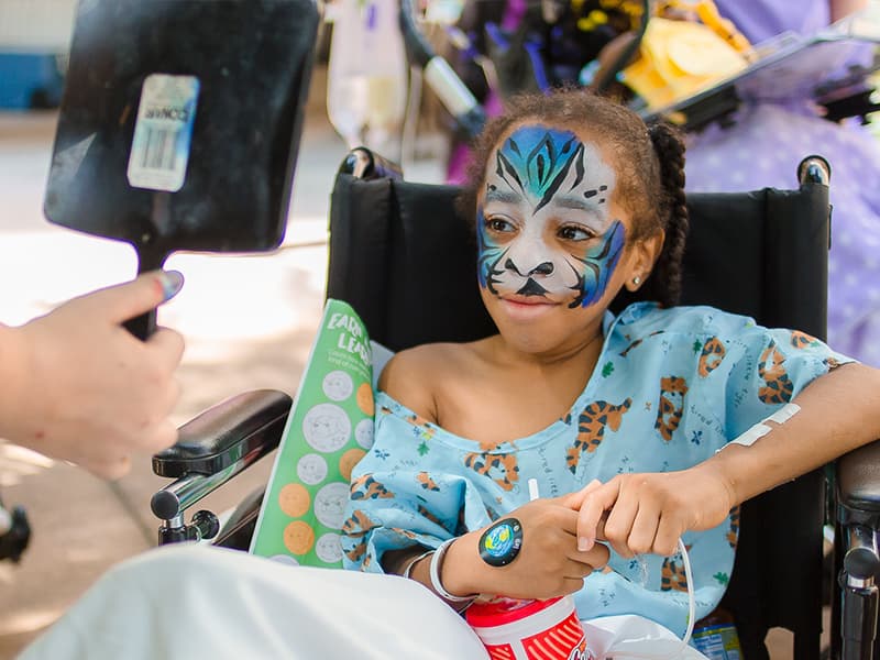 Batson Children's Hospital patient La'Quan Bradley of Natchez smiles at his tiger-painted reflection.