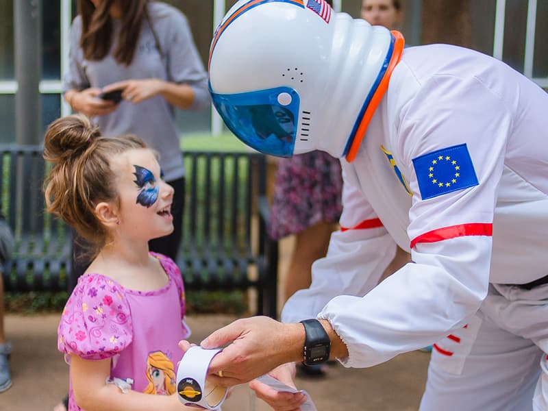 Batson Children's Hospital patient Emma Reynolds gets a sticker from an astronaut during the space-themed Mississippi Children's Museum Day at the hospital. The annual event is in its second year.