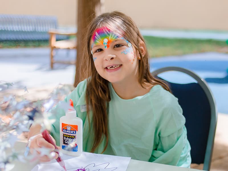 Batson Children's Hospital patient Brooklyn Cockrell of Tallulah, La., smiles as she creates rocket-inspired art during a space-themed Mississippi Children's Museum Day at the hospital.