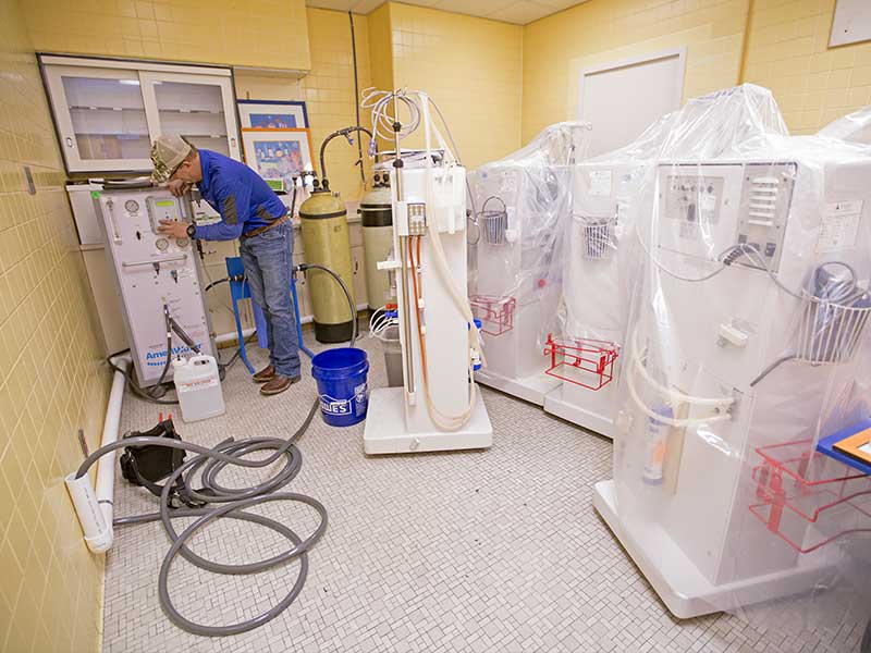 Brian Neely of Freeman Water Treatment installs temporary reverse osmosis treatment systems for a room within the Medical Center's dialysis unit that's not normally used for patient care.