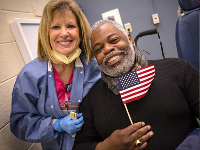 Donna Edwards, dental assistant, and Curtis Porter, U.S. Army veteran, are all smiles after his dental visit Thursday.