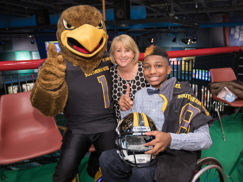 University of Southern Mississippi mascot Seymour and Mississippi First Lady Deborah Bryant congratulate the state's 2018 Children's Miracle Network Hospitals Champion KJ Fields at a Wednesday announcement at the Mississippi Sports Hall of Fame.