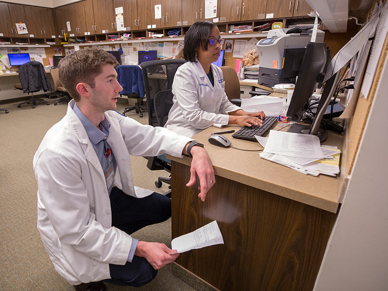 Fourth-year medical student Kyle Lacy and Dr. Kimberly Bibb, assistant professor of family medicine, use Epic to electronically record information on the patients they treat.