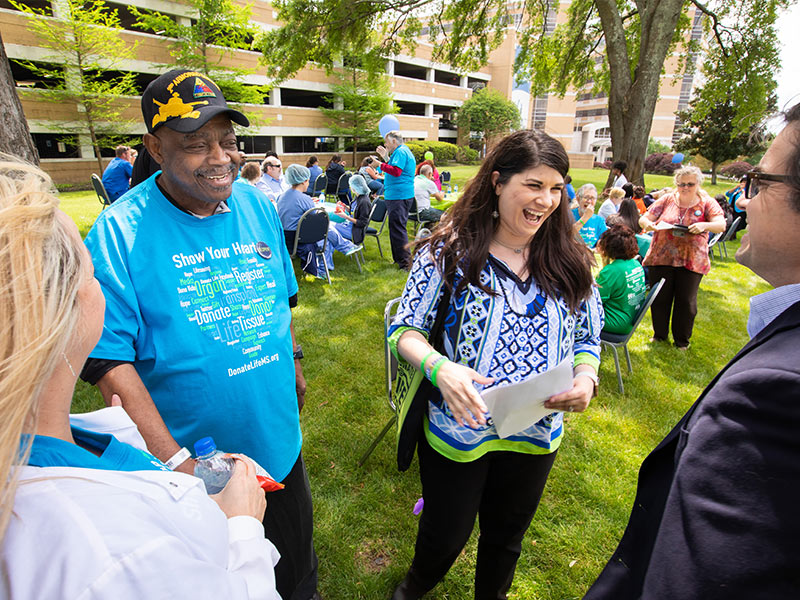 ones, left, and Kellie Wier, director of hospital development for the Mississippi Organ Recovery Agency, chat with friends during the April 13 Legacy Lap.