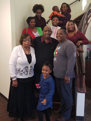 Jones, center, is surrounded by family members including his wife, Emma, wearing a white sweater.  Standing on the other side of Abram Jones is Lywanda White.