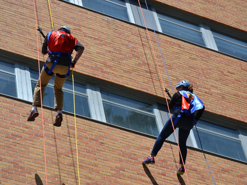 Funds raised by rappellers, or "Edgers," such as these two are still being totaled, but donations have surpassed the $162,000 mark.