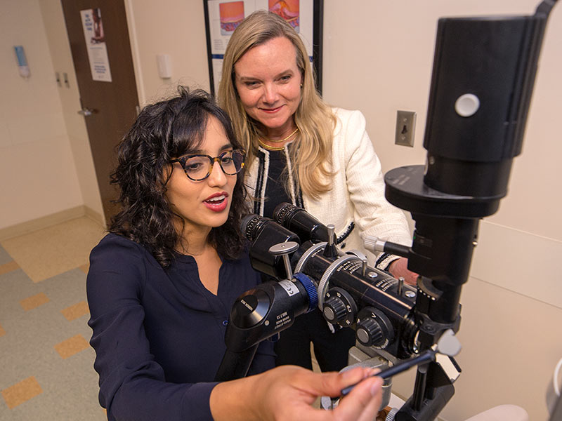 Dawoud and her mentor Dr. Kimberly Crowder, ophthalmology chair, review the merits of an optical instrument designed for glaucoma patients.