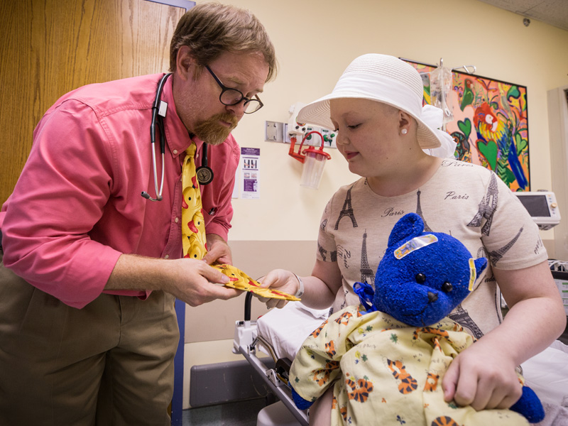 Children's Cancer Center patient Mary Frances Sutton of Monticello checks out Dr. Anderson Collier's rubber duckie tie.