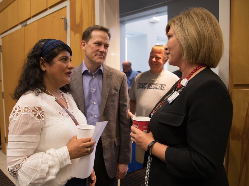 Dr. LouAnn Woodward, right, vice chancellor for health affairs and dean of the School of Medicine, greets Ray and Monica Harrigill during their Family Day visit to support first-year student Manish Harrigill.