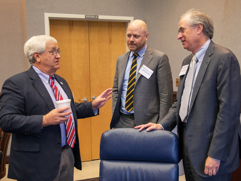 Dr. John Mitchell, left, chats with Paul Johnson, ACGME executive director and Institutional Review Committee member; and Dr. Kevin Weiss, ACGME senior vice president, in Institutional Accreditation.