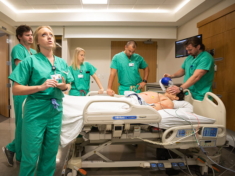 During one of several simulated emergency cases, Dr. Erin Walker, foreground, leads a team of her fellow Emergency Medicine residents:  from left, Dr. Macon Morris,  Dr. Paige Bell, Dr. Joshua Rouhan and Dr. Harold Gage.