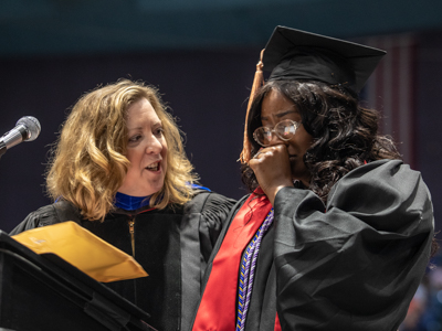 Trinity Brown, right, a Bachelor of Science in Nursing graduate, receives the Christine L. Oglevee Memorial Award from Dr. Mary Stewart, interim dean of the School of Nursing.