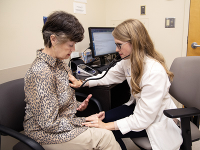 Dr. Lyssa Weatherly examines one of her patients, Judith Travs of Jackson. Weatherly, faculty advisor for the Gold Humanism Honor Society chapter, was an inducted as a medical student and was an honoree as a resident.