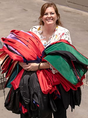 After UMMC's 2019 Commencement, Cole carries multicolored graduation robes away from another successful graduation ceremony at the Mississippi Coliseum.