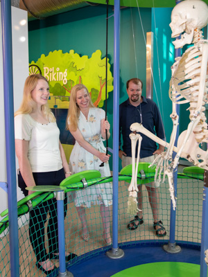 New residents Dr. Anna Beth Case, left, Dr. Alicia Snider and Dr. R.J. Case take turns pulling a rope to move the skeleton at the Boney-You exhibit in the Mississippi Children's Museum. New residents enjoyed time together at a June 27 party at the Mississippi Children's Museum.