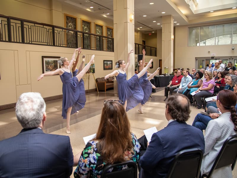 Dancers from Ballet Mississippi perform a selection for an audience of about 100 people gathered in the main lobby of the Medical Center.