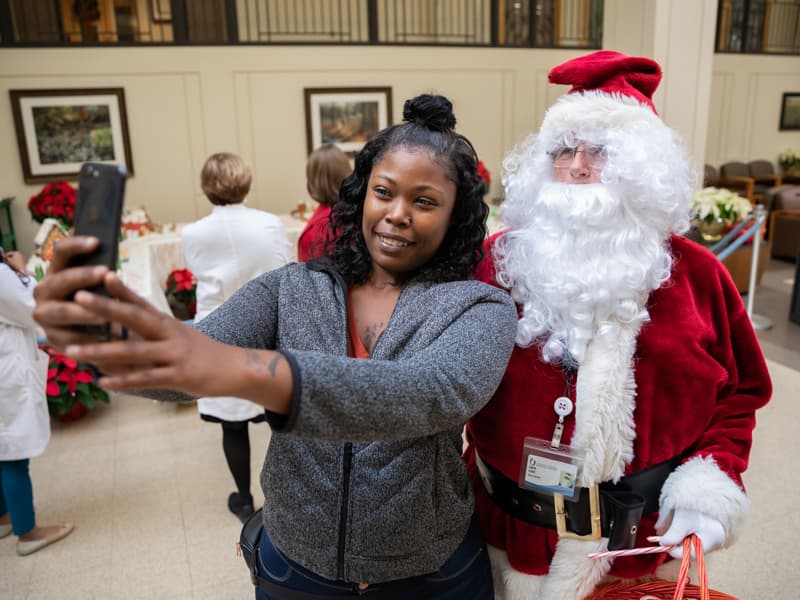 Alexis Jones of Jackson pauses to snap a selfie with Santa Claus while at UMMC to visit a patient.