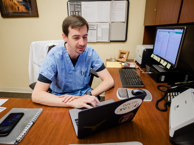 Normally, nurse practitioner and head of the Lung Cancer Early Detection Program Jonathan Hontzas spends his days seeing patients in clinic. He is now using his skills to screen individuals via telehealth who call in to the COVID-19 hotline.