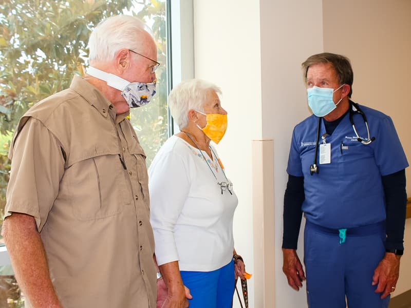 University of Mississippi Medical Center cardiologist Dr. Bryan Barksdale, right, chats with patient John Orton and Orton's wife, Linda.
