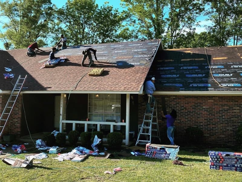 Contractor workers for H&S Roofing and Home Repair, a venture co-owned by Casey Spell and Chris Hare, get busy on a recent project in the Jackson area.
