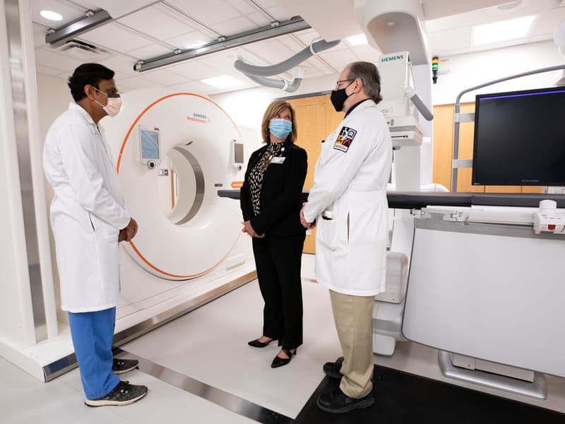 From left, Dr. Akash Patel, chief of the Division of Interventional Radiology; Dr. LouAnn Woodward, vice chancellor for health affairs and School of Medicine dean; and Dr. Timothy McCowan, chair of the Department of Radiology, chat at ribbon-cutting ceremonies for the new Interventional Radiology Suite.