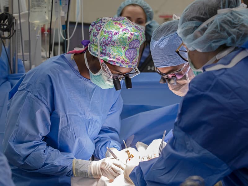 Dr. Praise Matemavi, left, performs surgery recently at UMMC as general surgery resident Dr. Jad Chamieh, center, and fourth-year medical student Savannah Walker observe.