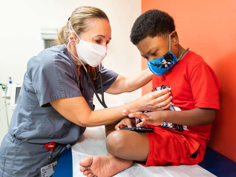 Children's of Mississippi cardiologist Dr. Jennifer Shores listens to the heartbeat of her patient, Levi.