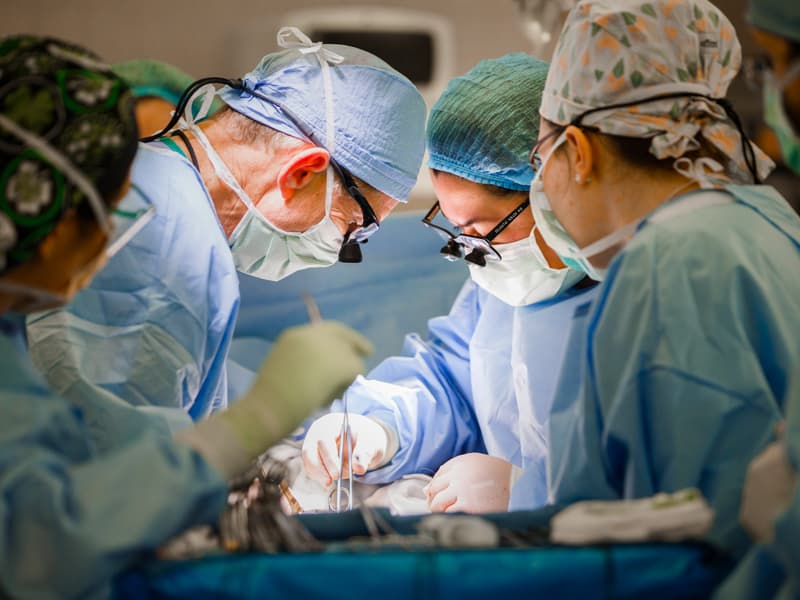 Dr. James Wynn, second from left, and Dr. Felicitas Koller, second from right, abdominal transplant surgeons, complete a kidney transplant for Hugh Smith on Feb. 18.