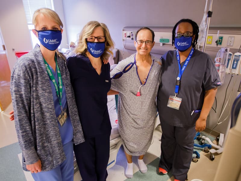 Checking in with kidney transplant patient Hugh Smith, second from right, before Smith's discharge are from left, registered nurse transplant coordinators Brandi Garcie and Shelly Watts, and licensed social worker Sherie Brock.