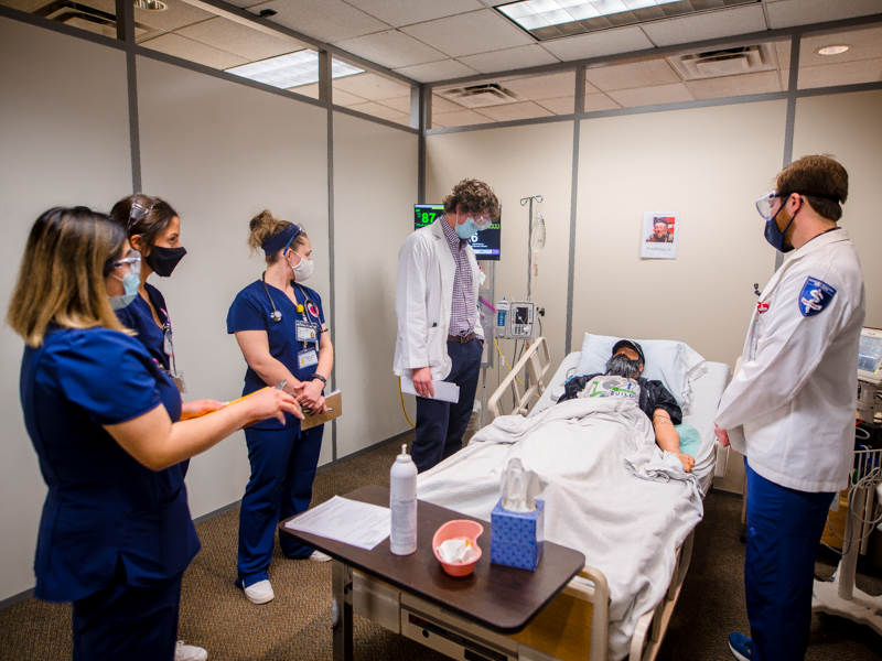 Listening to Pete, voiced by assistant professor of nursing Nikki Lee, are, from left, pharmacy student Xingyu Pan, nursing students Madeline Nicosia and Weslee Patti, and medical students Luke Wojohn and and Johnathan Breaux.
