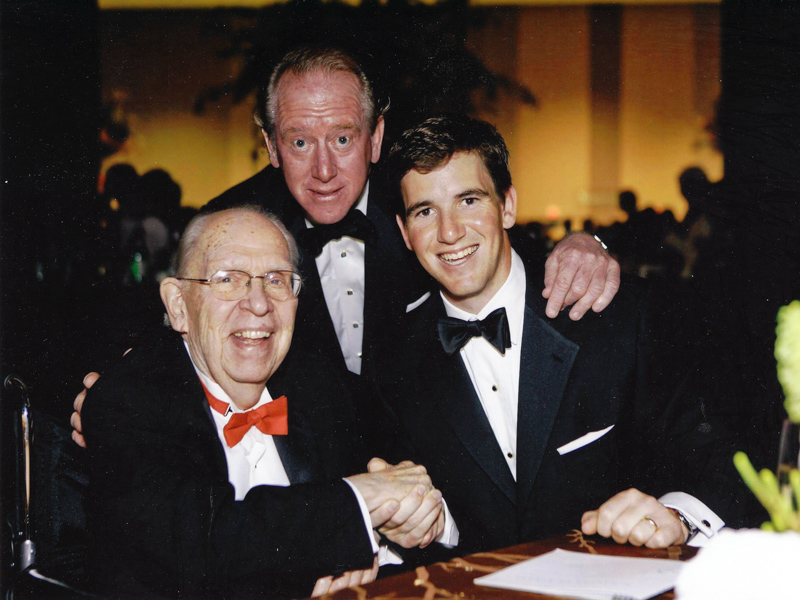 Batson is shown with Mississippi football greats Archie Manning, center, and son Eli Manning.