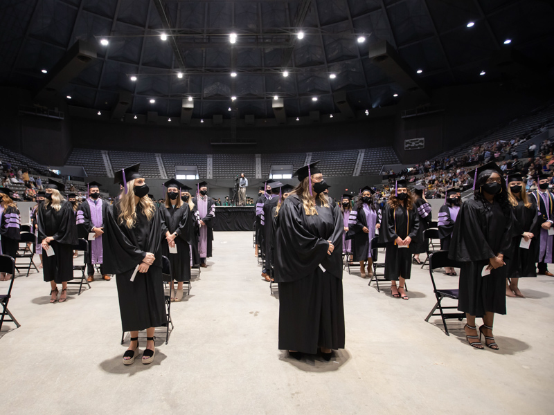 Students in the School of Dentistry stand at attention, waiting for their turn on the stage at the University of Mississippi Medical Center's 65th annual commencement held May 28 at the Mississippi Coliseum.