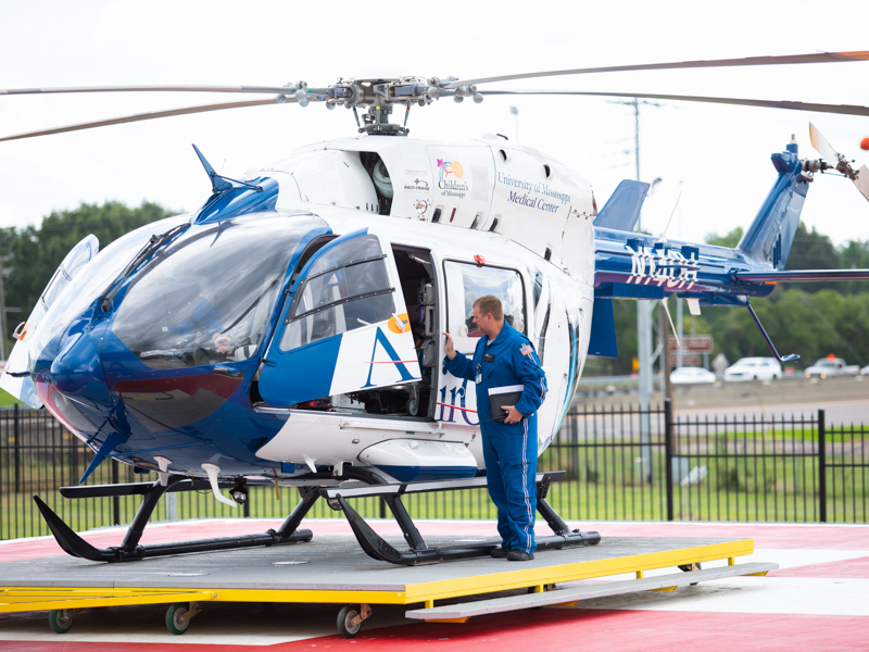 Kevin King, a flight nurse on AirCare 1, based at the Mississippi Center for Emergency Services on the UMMC campus, checks the aircraft following its return to an MCES hangar after delivering a patient to the helipad atop the Conerly Critical Care Hospital.