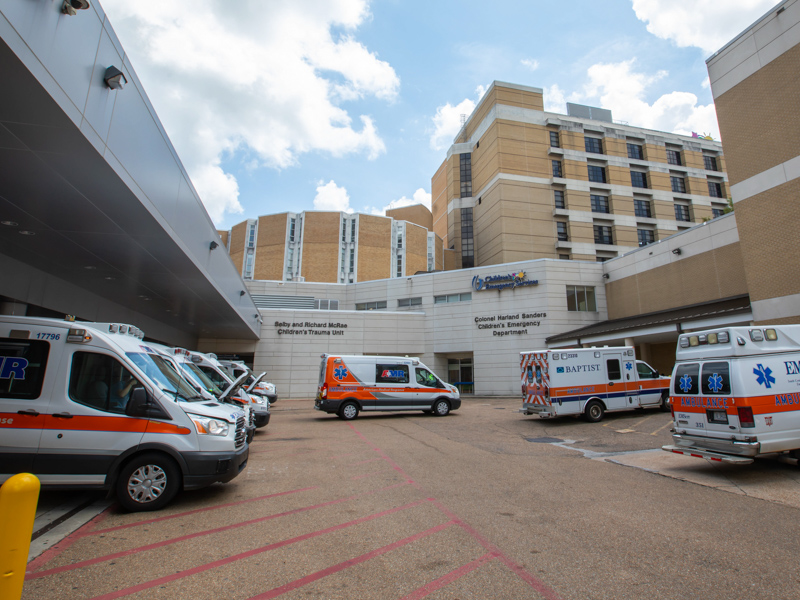 Ambulances line up outside the Emergency Department, taking up all bays and overflowing onto the adjacent pavement. 
