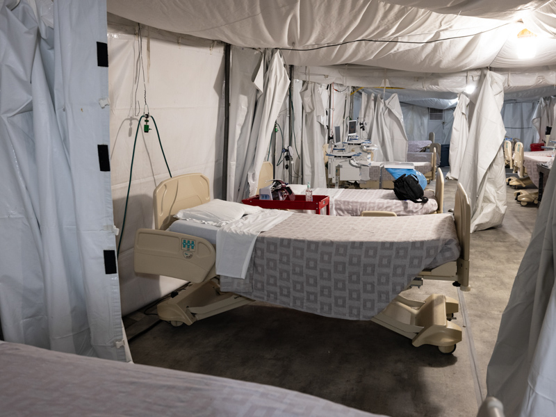 A row of hospital beds inside the field hospital for COVID-19 low-acuity patients await patients Friday.