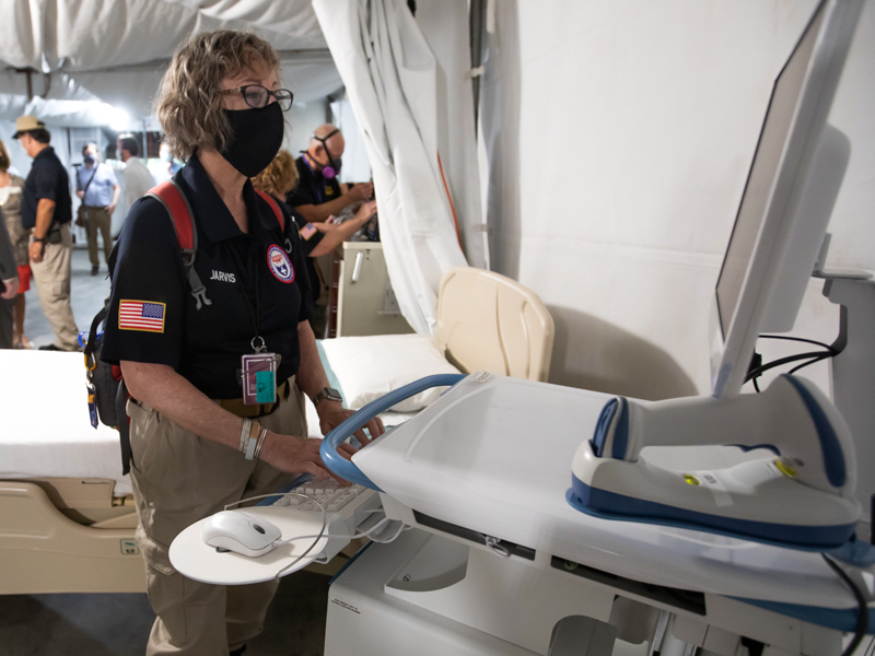 Raelene Jarvis of Oregon with the National Disaster Medical System team tries out the computer system in the mobile field hospital located in garage B of the University of Mississippi Medical Center following a press conference Thursday, Aug. 12.