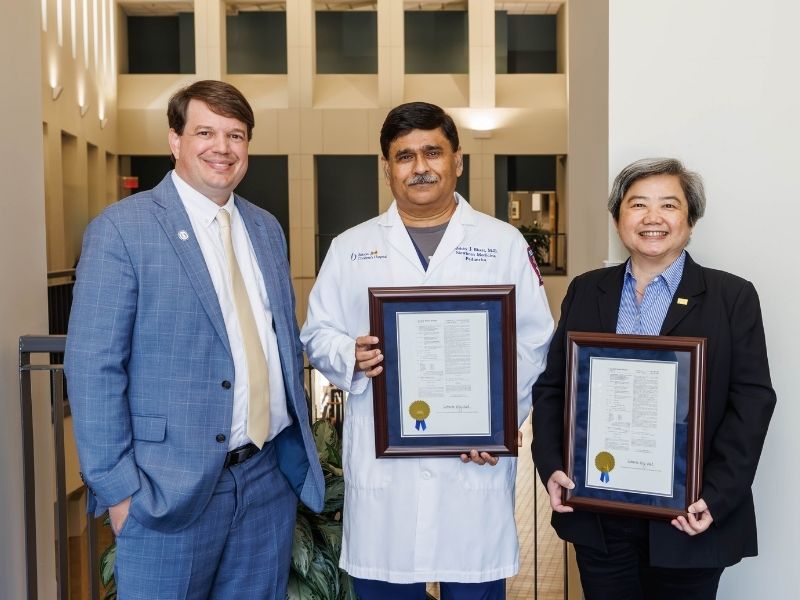 Patent recipients include Dr. Abhay Bhatt, center, and Dr. Lir-Wan Fan, right. At left is Dr. Gene Bidwell.