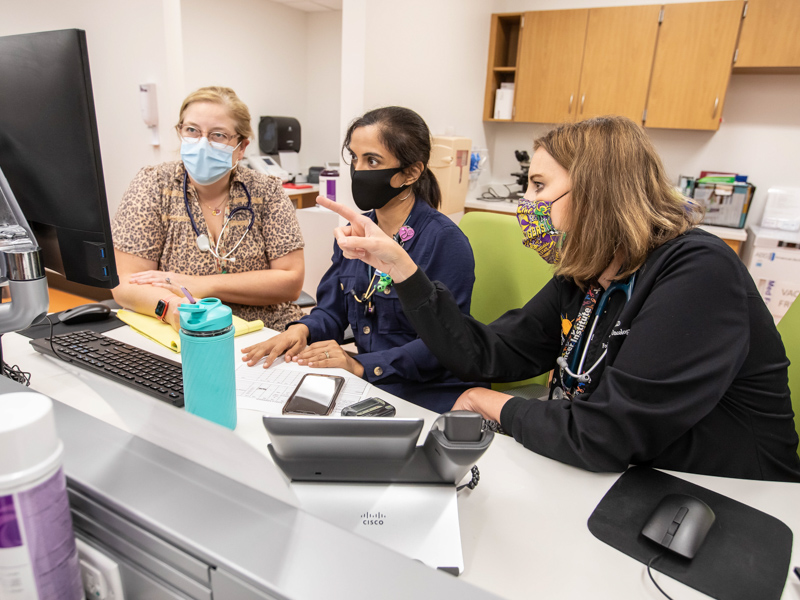 From left, Dr. Charlotte Hobbs, Dr. Anita Dhanrajani and Dr. Catherine Gordon discuss patient care at the collaborative MIS-C clinic in the Kathy and Joe Sanderson Tower at Children's of Mississippi.