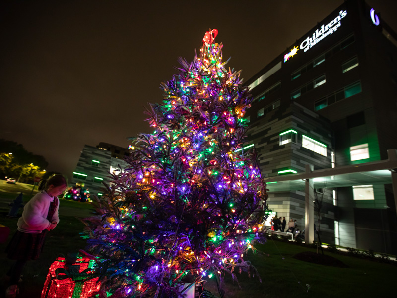 Five-year-old Magee VanDevender looks at the freshly lit Christmas tree outside the Kathy and Joe Sanderson Tower. Magee is the daughter of Friends of Children's Hospital board member William VanDevender Jr.