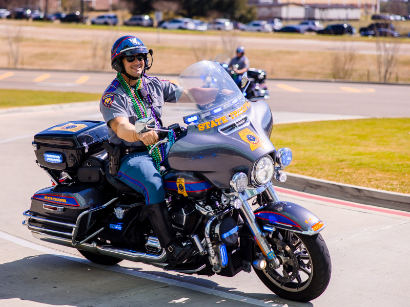 Mississippi Highway Patrol officers wore beads while riding motorcycles in the Department of Public Safety's Mardi Gras parade at Children's of Mississippi Thursday.
