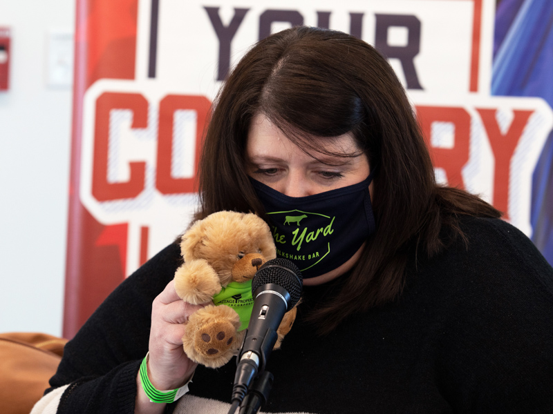 U.S. 96 program director and Morning Show co-host Traci Lee broadcasts with a furry friend, a "Blair Bear" from Heritage Properties during the 2021 Mississippi Miracles Radiothon.